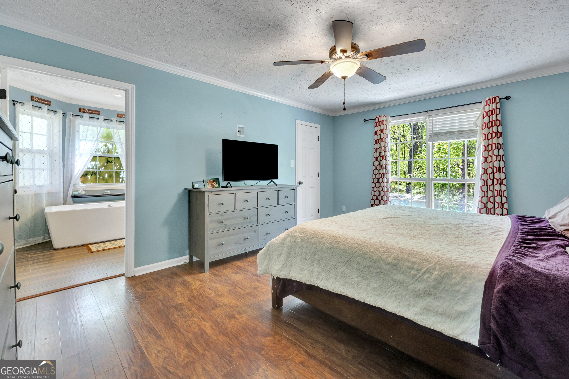 115 Crestview Lane Newborn, GA 30056 - Photo 20 of 53 a bedroom with a bed and a flat screen tv