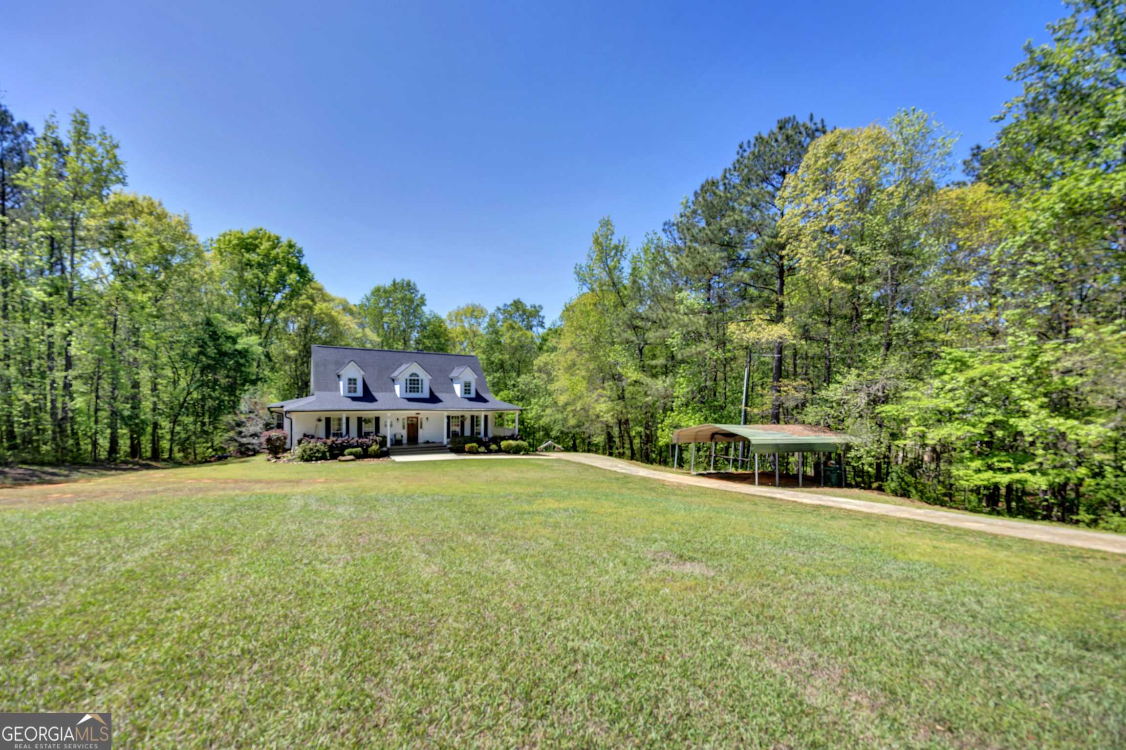 115 Crestview Lane Newborn, GA 30056 - Photo 2 of 53 a front view of a house with a yard and garage