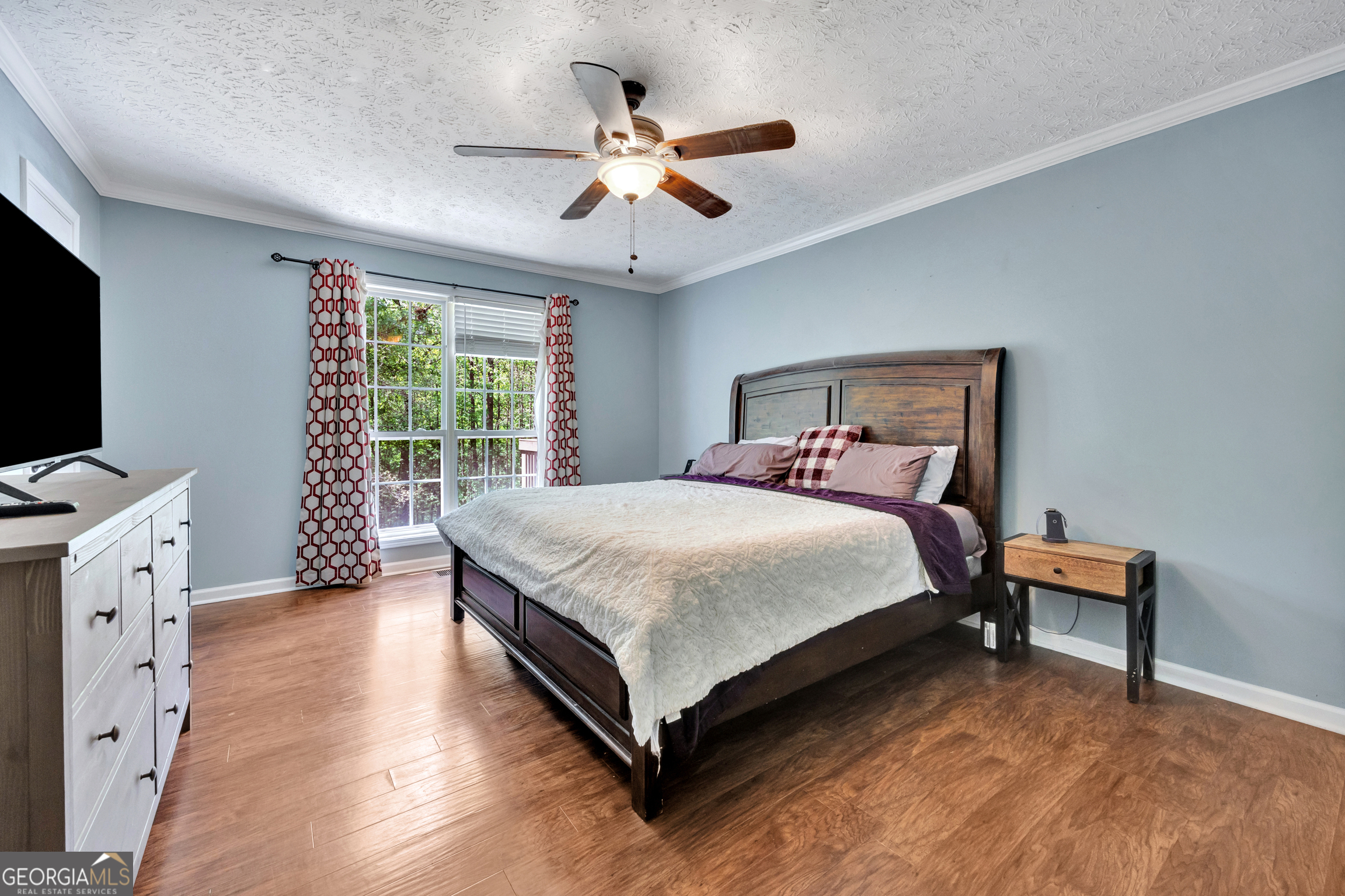 115 Crestview Lane Newborn, GA 30056 - Photo 21 of 53 a bedroom with a large bed and a flat tv screen on dresser