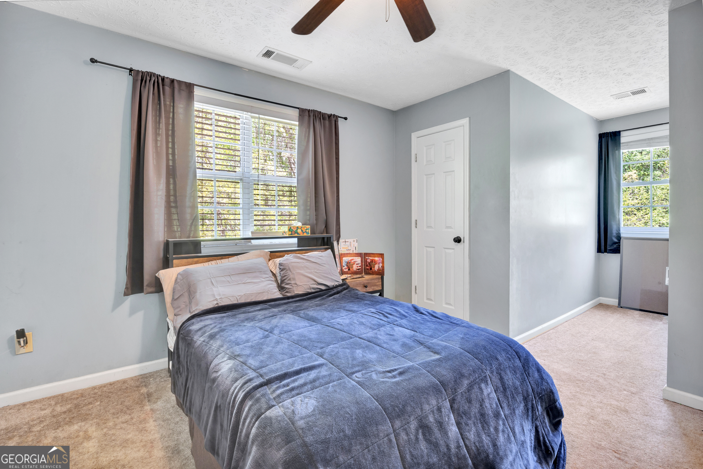115 Crestview Lane Newborn, GA 30056 - Photo 32 of 53 a large bed sitting in a bedroom next to a window and a chandelier