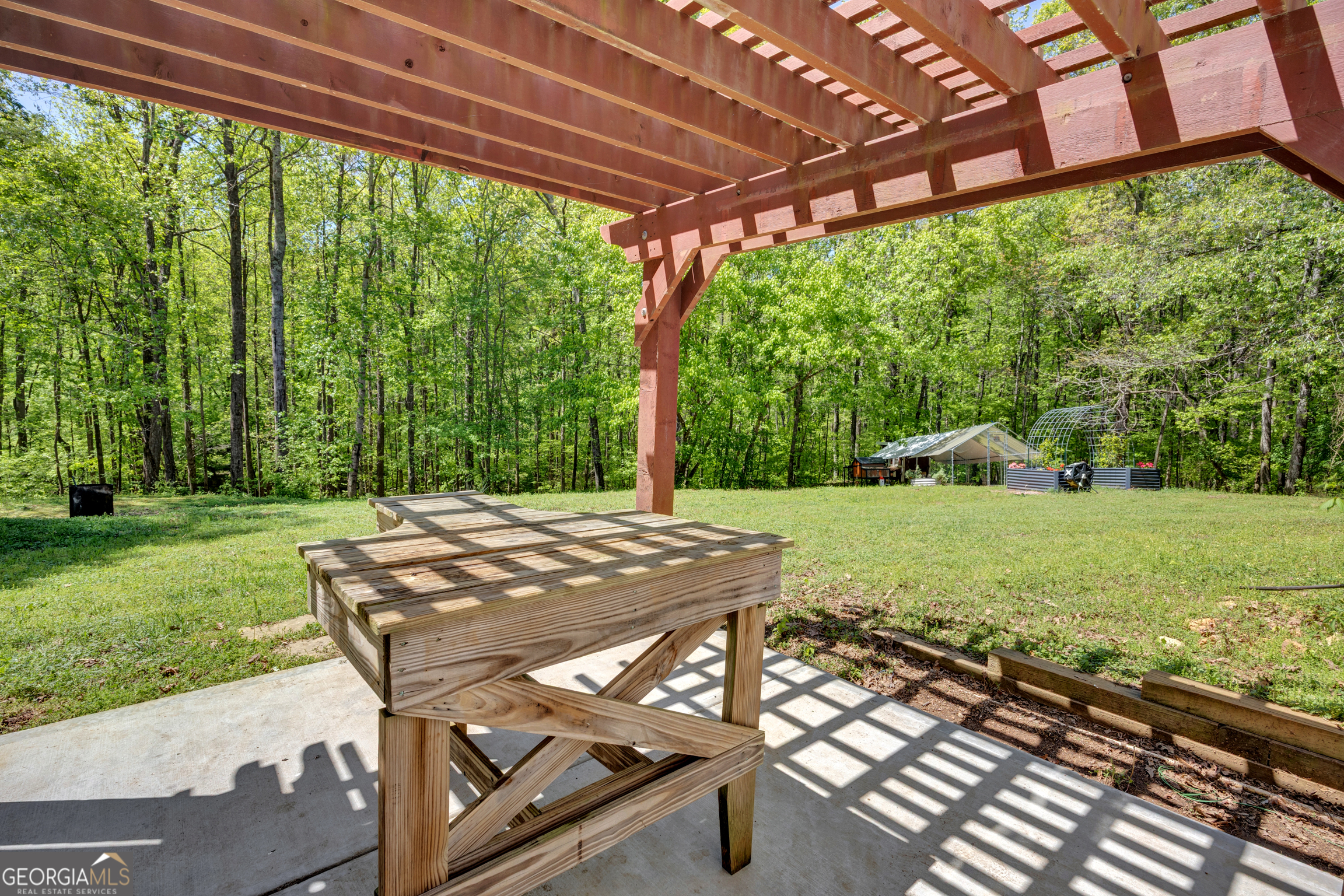 115 Crestview Lane Newborn, GA 30056 - Photo 41 of 53 a view of a patio with a table chairs and a yard