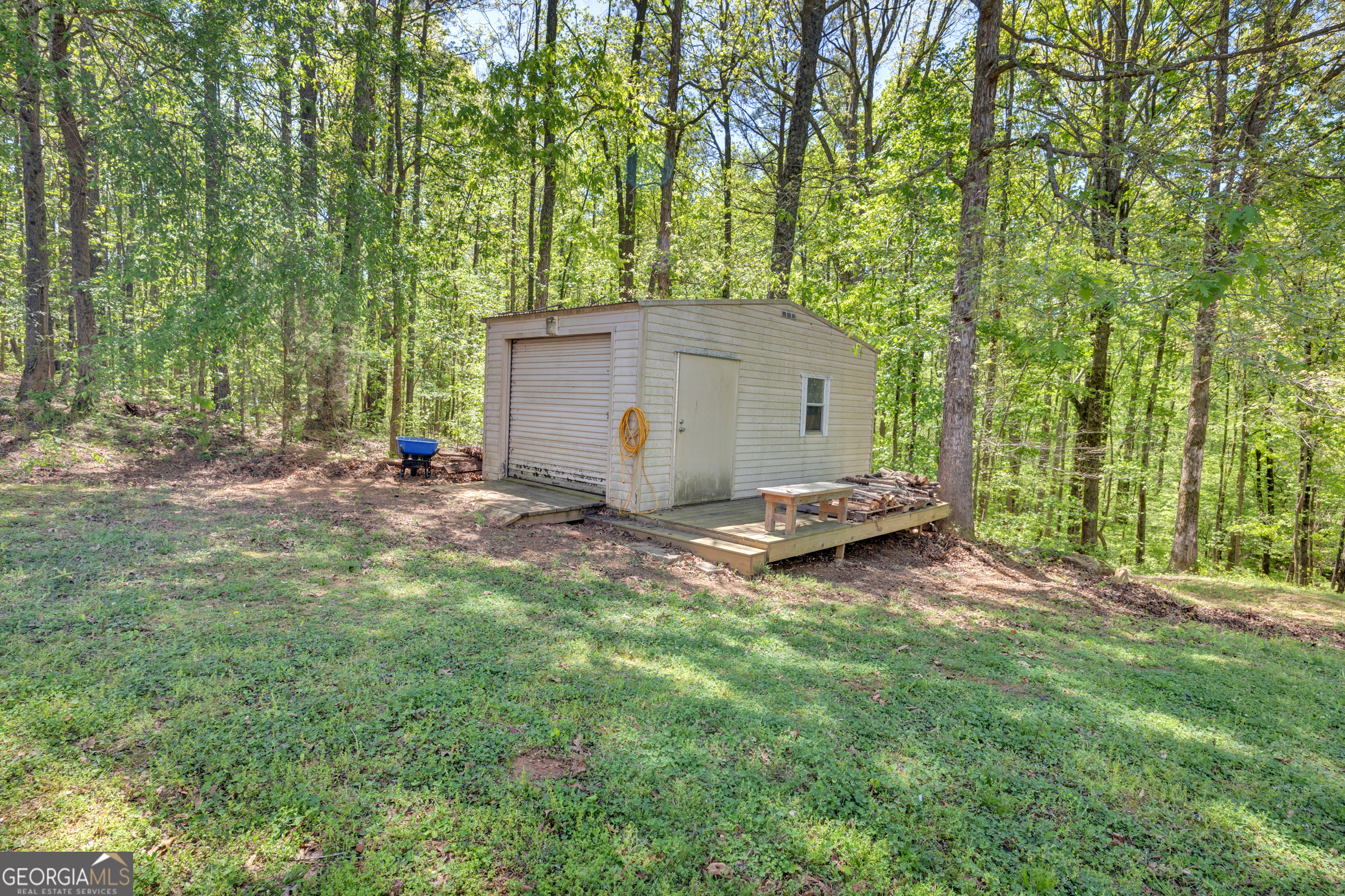 115 Crestview Lane Newborn, GA 30056 - Photo 42 of 53 a view of backyard with a barn and large trees