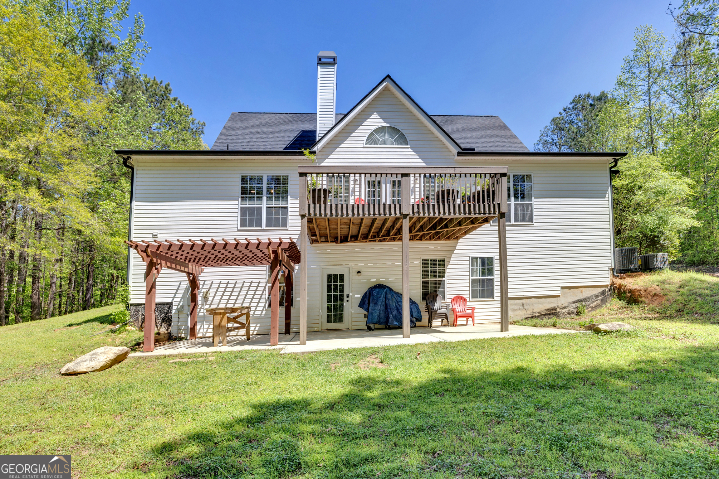 115 Crestview Lane Newborn, GA 30056 - Photo 44 of 53 a front view of a house with a yard table and chairs