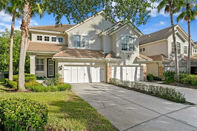 a front view of a house with a garden and plants