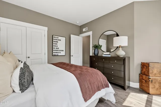 a bathroom with a bathtub shower sink vanity mirror and toilet
