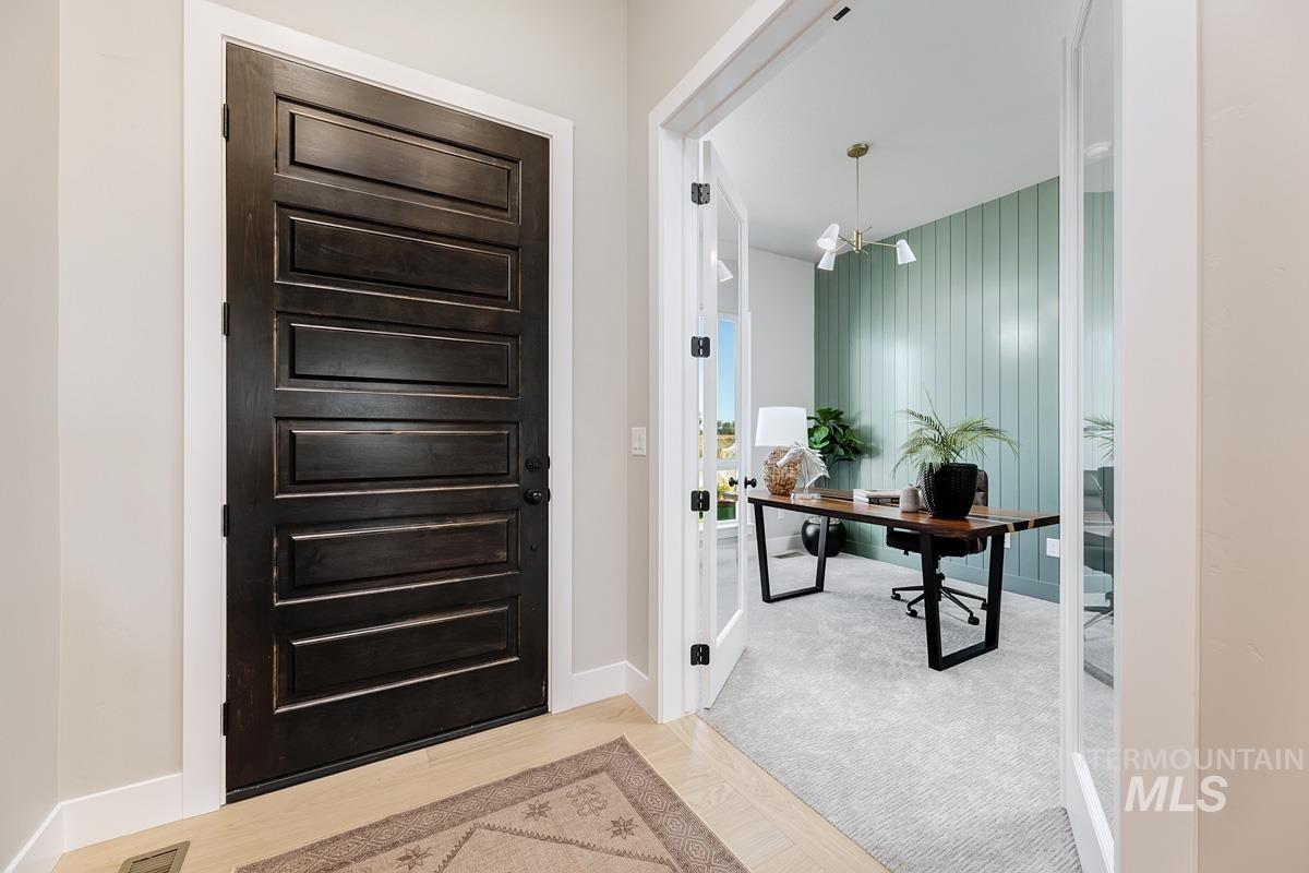 6909 Campolina Way Star, ID 83669 - Photo 12 of 39 Entryway featuring a desk, a chandelier, and wood finished floors