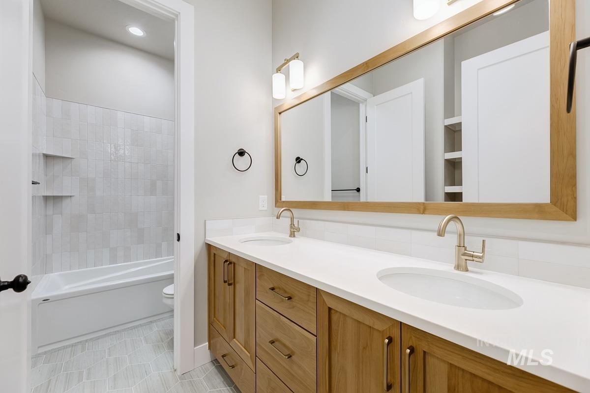 6909 Campolina Way Star, ID 83669 - Photo 22 of 39 Bathroom with bathtub / shower combination, double vanity, and light tile patterned flooring