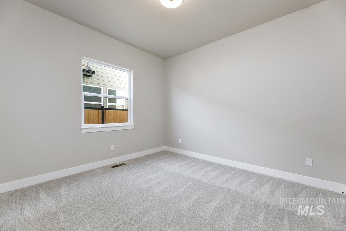 6909 Campolina Way Star, ID 83669 - Photo 23 of 39 Empty room featuring carpet flooring and baseboards