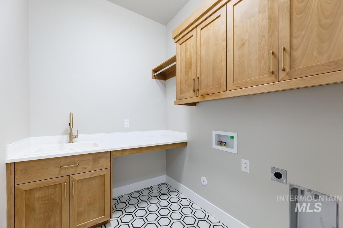 6909 Campolina Way Star, ID 83669 - Photo 24 of 39 Laundry area featuring washer hookup, hookup for an electric dryer, and cabinet space