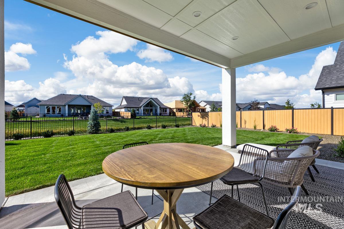 6909 Campolina Way Star, ID 83669 - Photo 26 of 39 Fenced backyard featuring a patio area, a residential view, and outdoor dining space