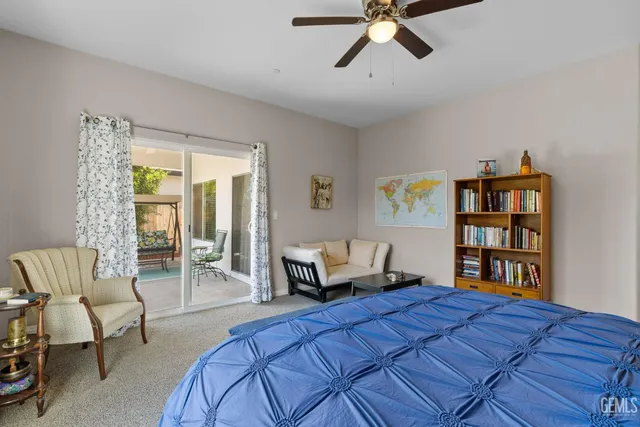 a bedroom with a bed furniture and a book shelf