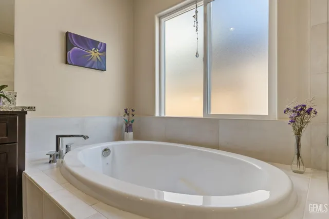 a bathroom with a bathtub and a window