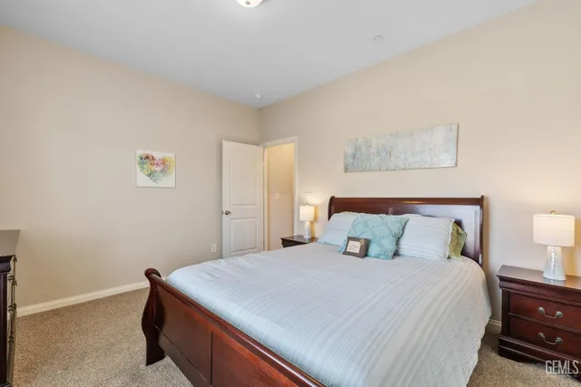 a bedroom with a bed and a night stand