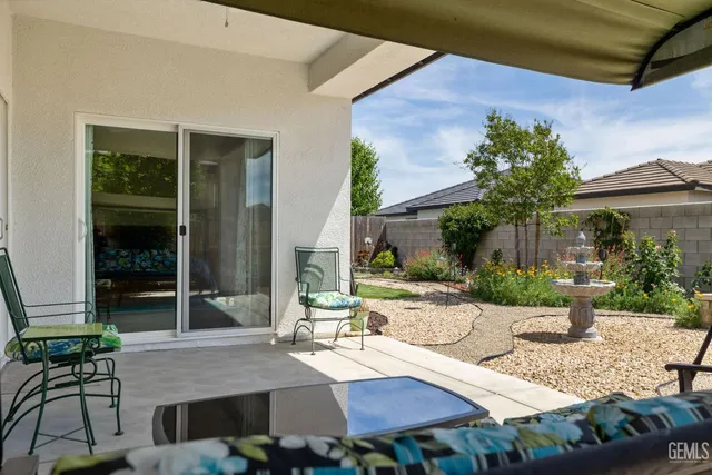 a view of a patio with table and chairs and potted plants