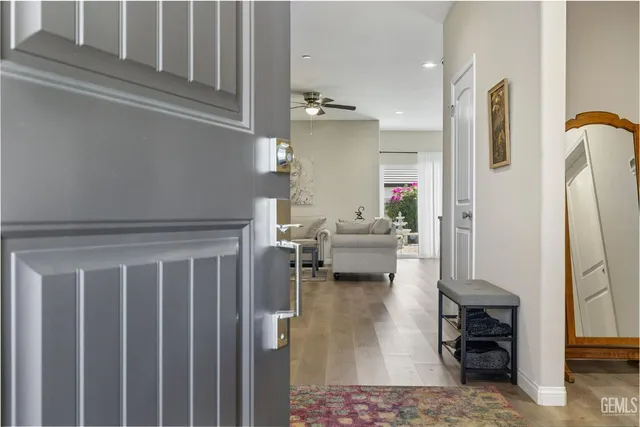 a living room with furniture and a mirror