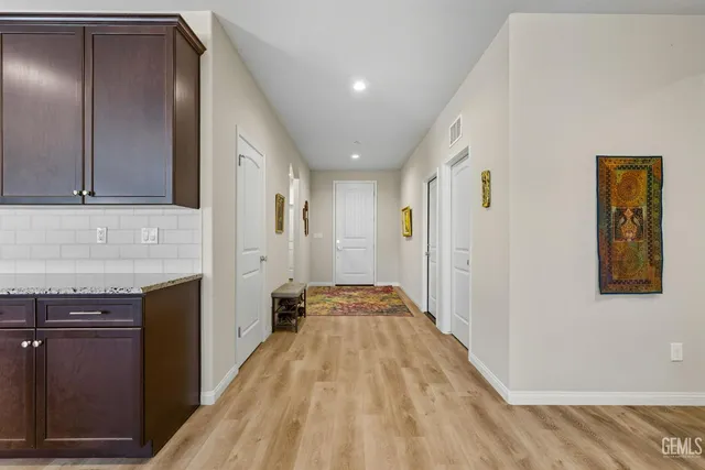 a view of a hallway with wooden floor and staircase