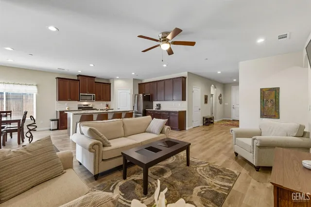 a living room with furniture and kitchen view
