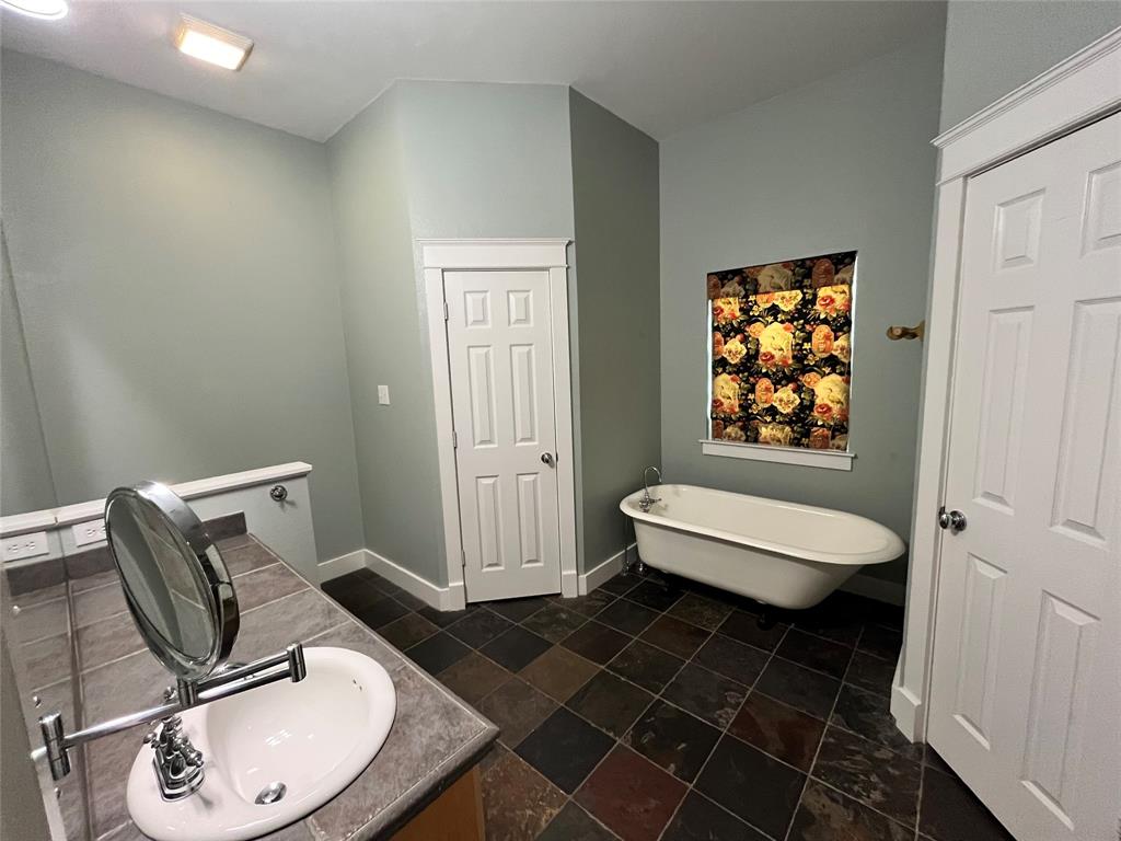 709 Roberts Street Denton, TX 76209 - Photo 13 of 35 Spa-like bathroom with a soaking tub and separate walk-in shower.