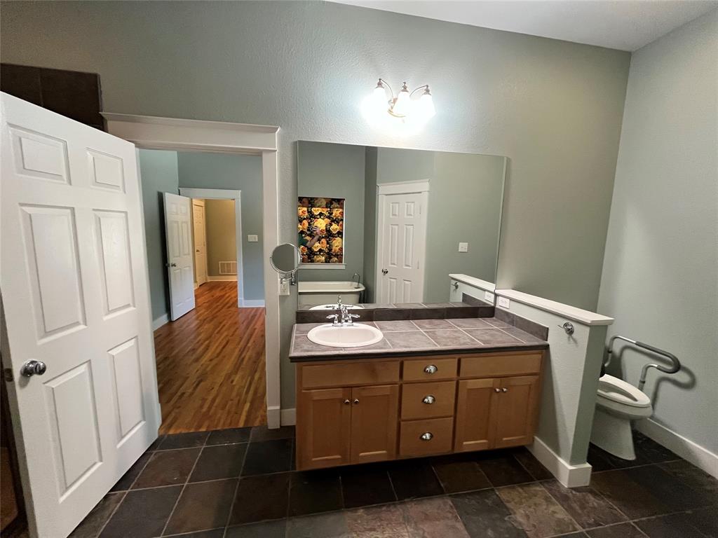 709 Roberts Street Denton, TX 76209 - Photo 14 of 35 Bathroom vanity with plenty of counter space and large mirror.
