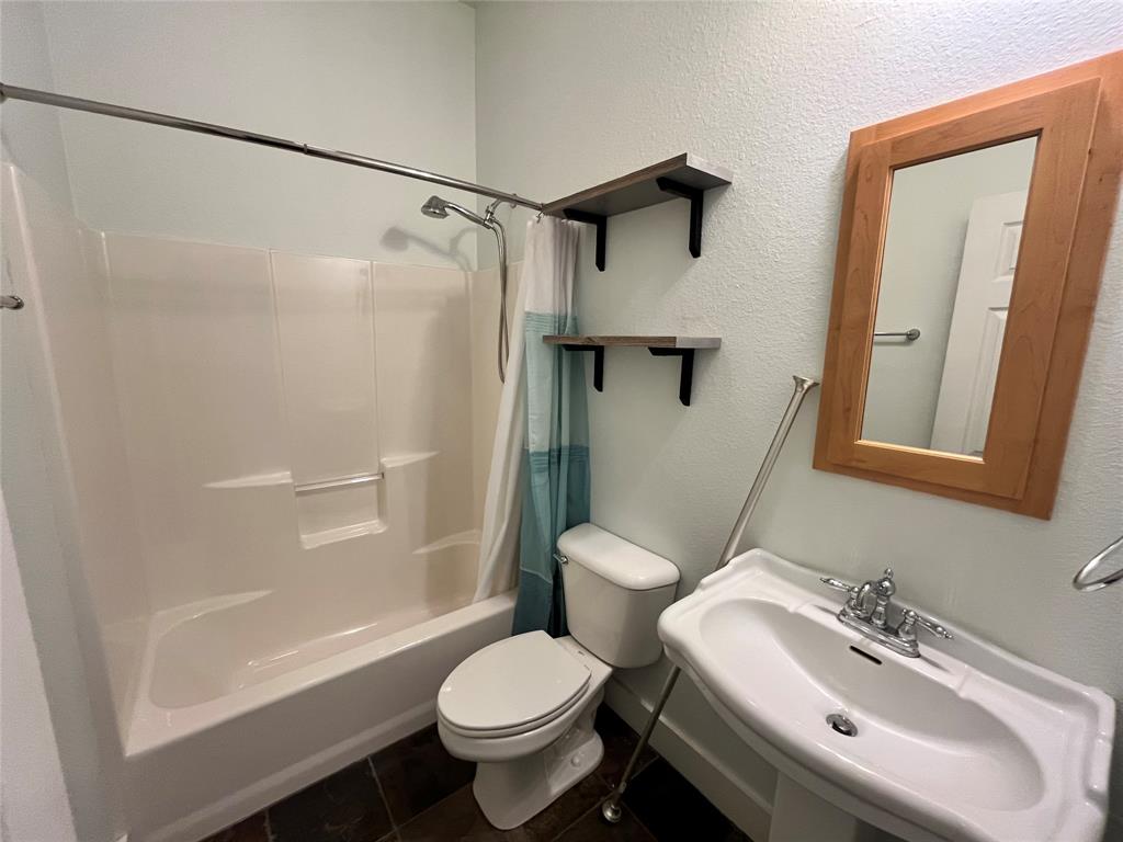 709 Roberts Street Denton, TX 76209 - Photo 19 of 35 Second full bathroom with a clean, classic design.