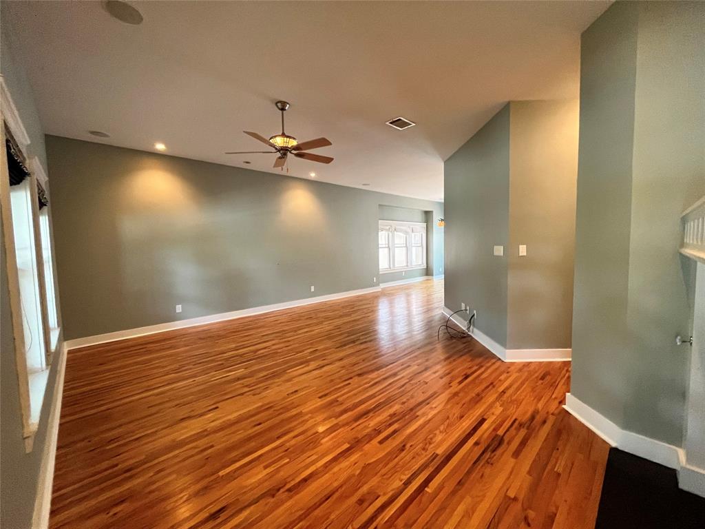 709 Roberts Street Denton, TX 76209 - Photo 2 of 35 Open-concept living space with beautiful wood floors and high ceilings.