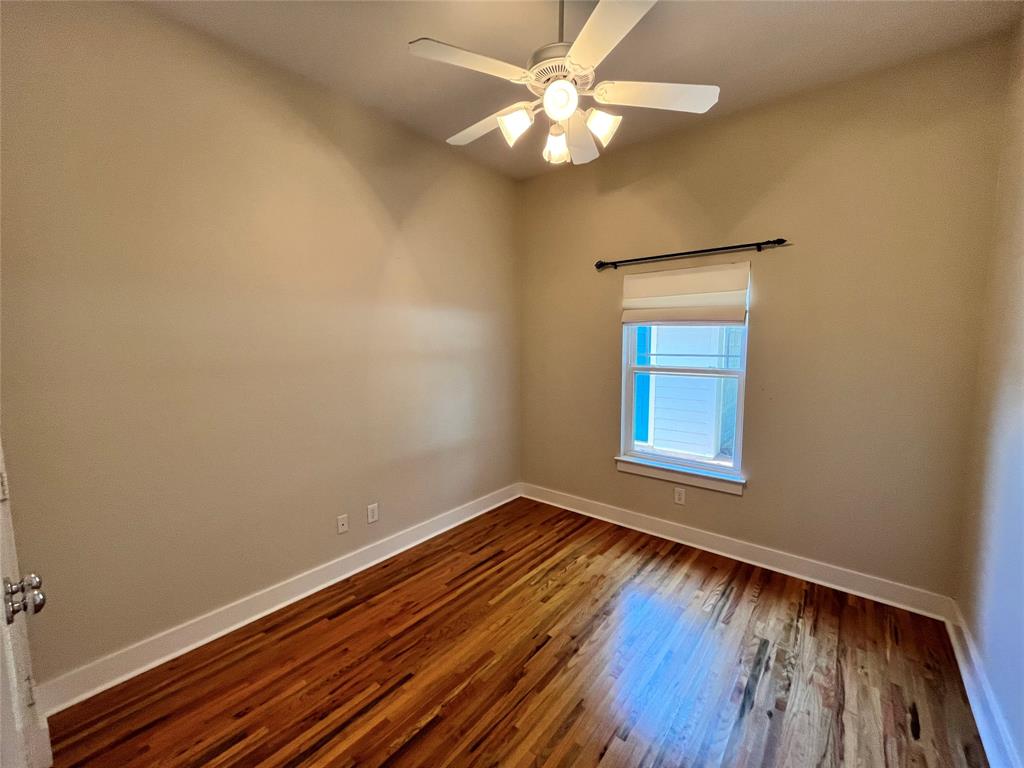 709 Roberts Street Denton, TX 76209 - Photo 21 of 35 Second bedroom with a ceiling fan and large window.