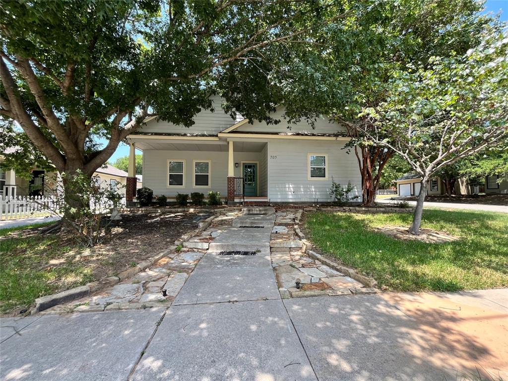 709 Roberts Street Denton, TX 76209 - Photo 32 of 35 Wide shot of the front yard and paved walkway.