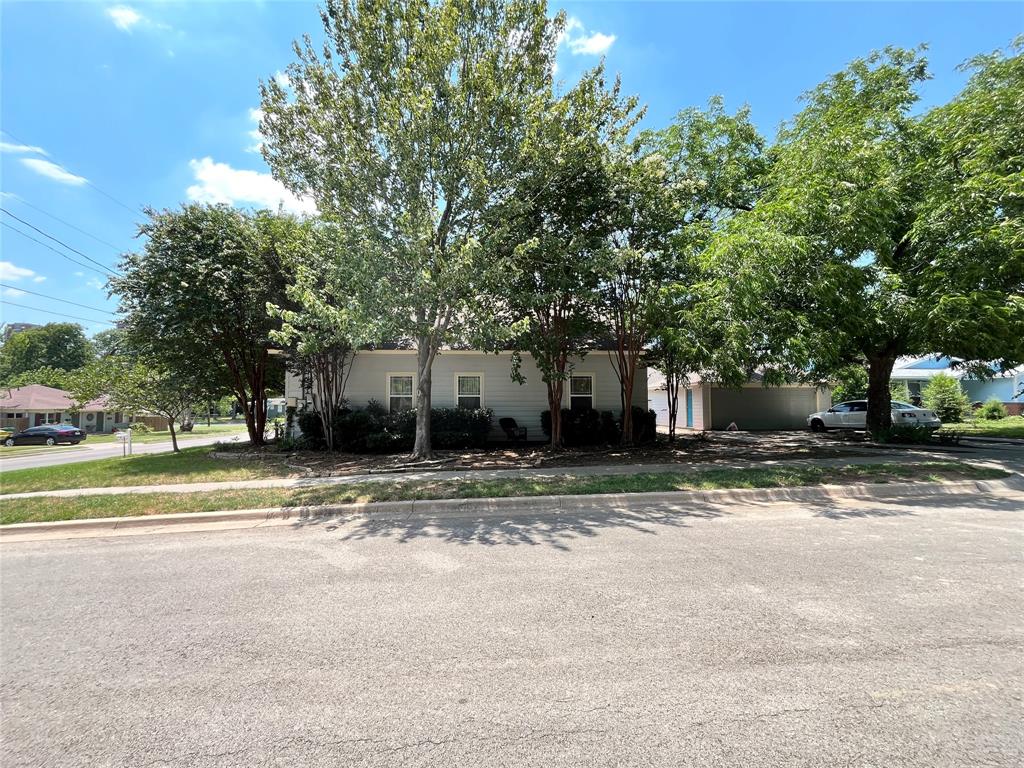709 Roberts Street Denton, TX 76209 - Photo 33 of 35 Full view of the home nestled among trees.