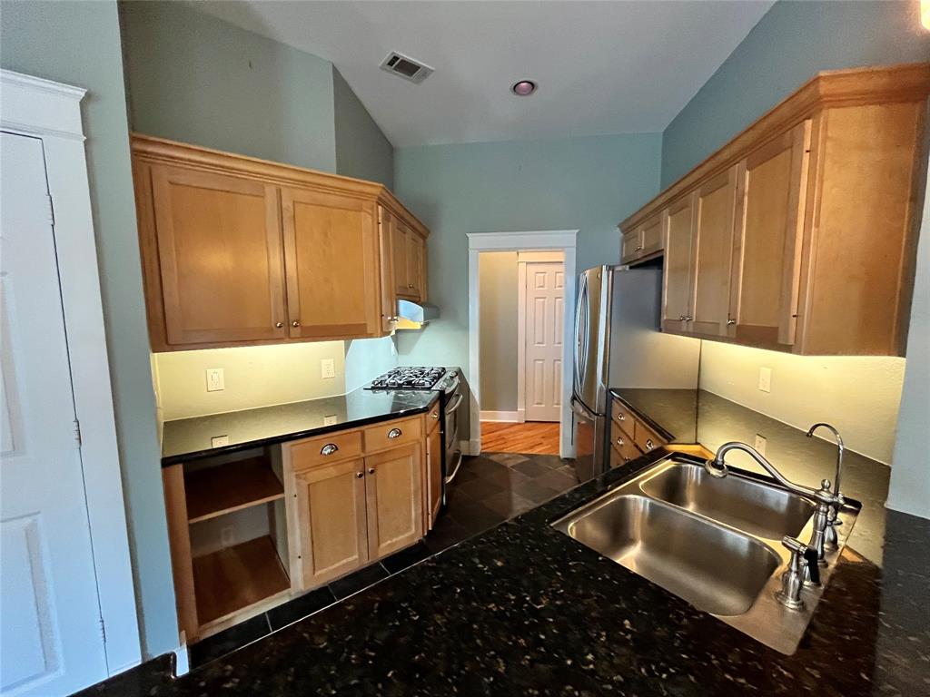 709 Roberts Street Denton, TX 76209 - Photo 6 of 35 Updated kitchen with plenty of cabinet space and dark countertops.
