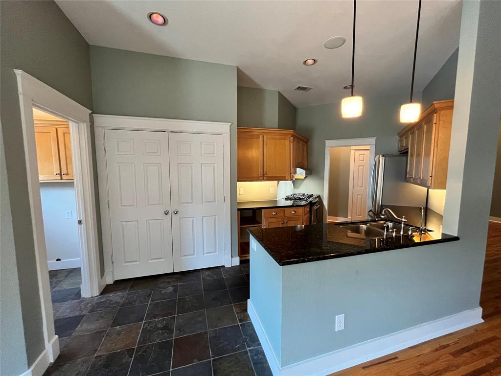 709 Roberts Street Denton, TX 76209 - Photo 8 of 35 Modern kitchen island with a breakfast bar for quick meals.