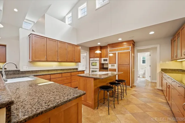 a kitchen with stainless steel appliances granite countertop sink stove and refrigerator