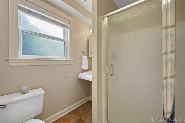 a bathroom with a toilet a sink and a mirror