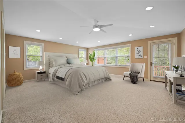 a bedroom with bed and a large window