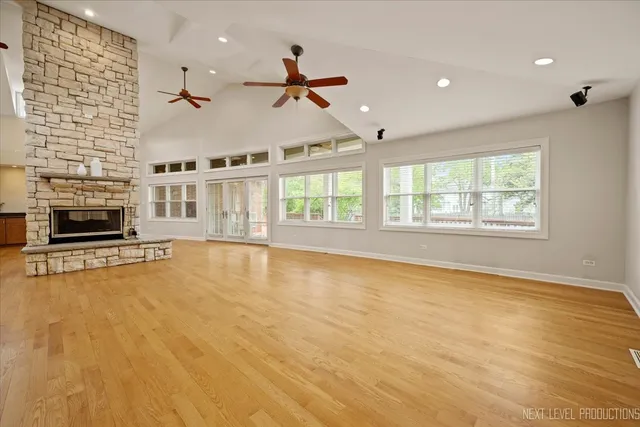 an empty room with fireplace and windows