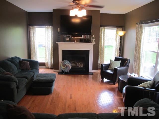 100 Key Biscayne Court Raleigh, NC 27603 - Photo 8 of 24 a living room with furniture a flat screen tv and a fireplace