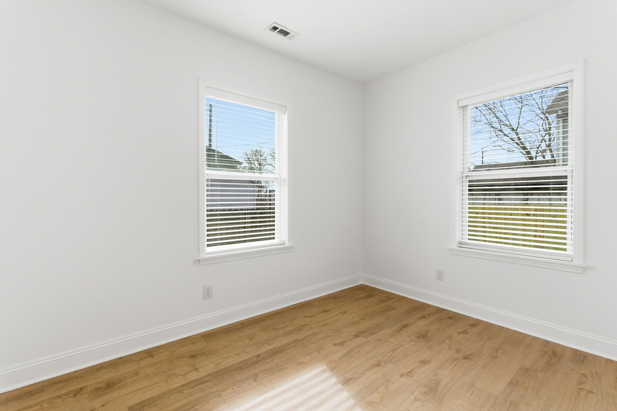 1106 Dodson Street Old Hickory, TN 37138 - Photo 19 of 27 a view of an empty room with wooden floor and a window