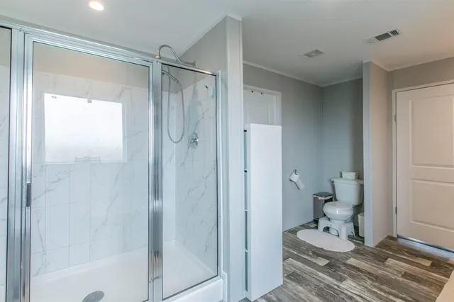 a bathroom with a shower and a toilet
