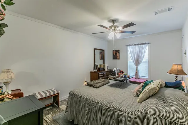 a bed room with a bed and a chandelier