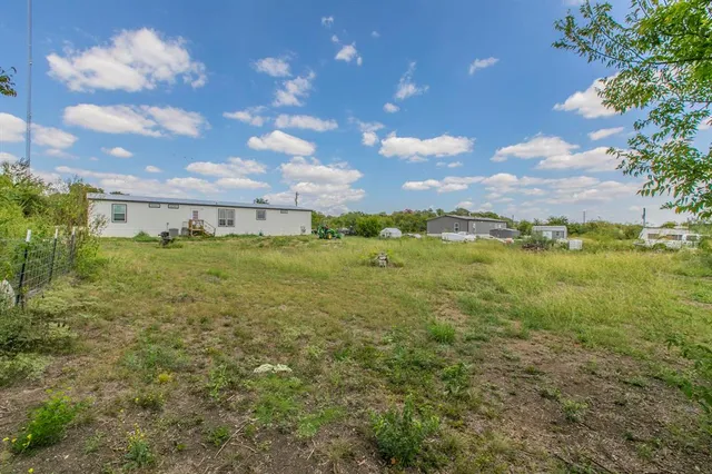 a view of a big yard with lots of green space