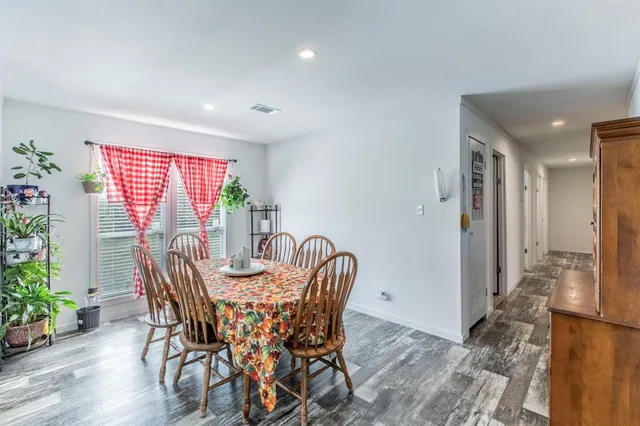 a dining room with furniture and wooden floor
