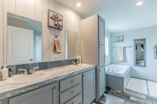 a bathroom with a granite countertop sink mirror and a