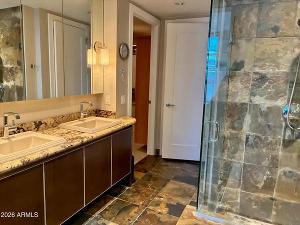 a bathroom with a granite countertop sink and a mirror