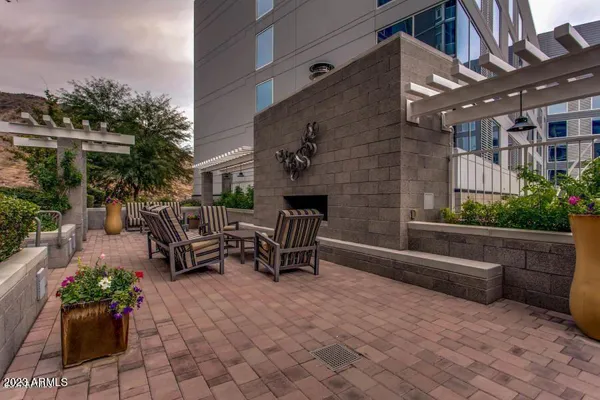 a building outdoor space with patio furniture and potted plants