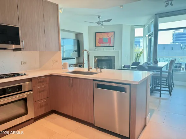 a kitchen with stainless steel appliances a sink and cabinets
