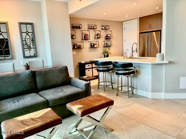 a living room with furniture a rug and a wall painting