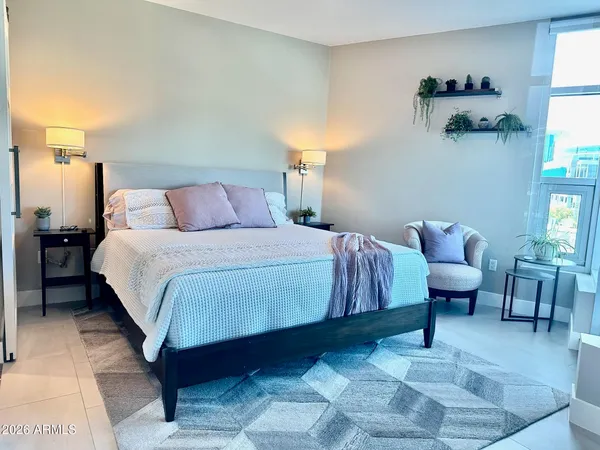 a bedroom with a bed and window