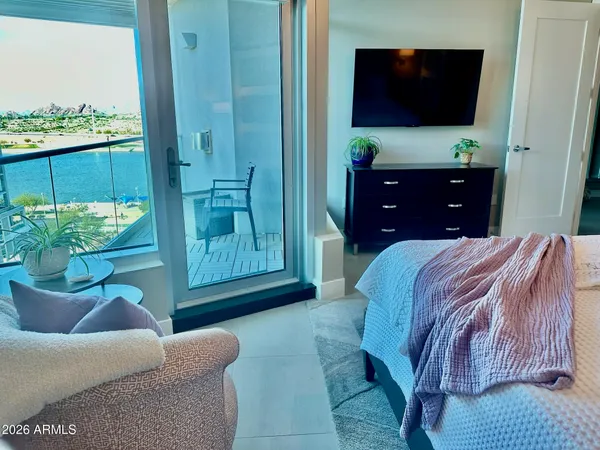 a bedroom with a bed and flat screen tv