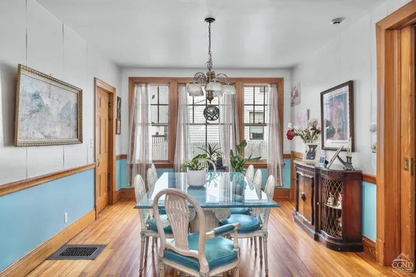 a view of a dining room with furniture chandelier and wooden floor