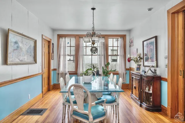 a view of a dining room with furniture chandelier and wooden floor
