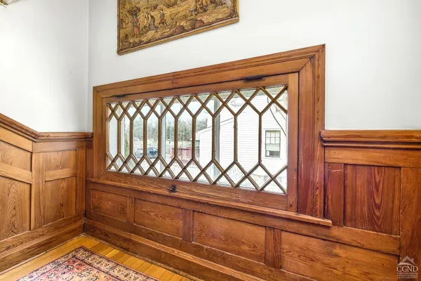 a view of front door with furniture and wooden floor